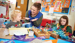 Early Years Practitioner communicating with an Early Years child.